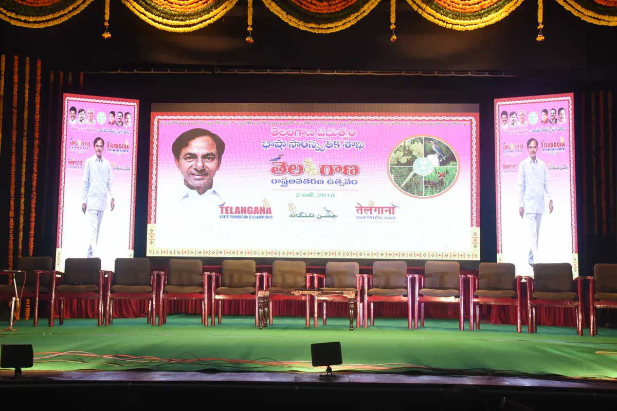 A brightly lit awards-ceremony stage in front of an audience.