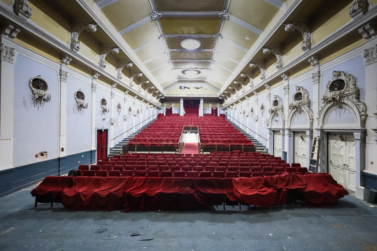 The interior of a cinema auditorium with rows of seats.