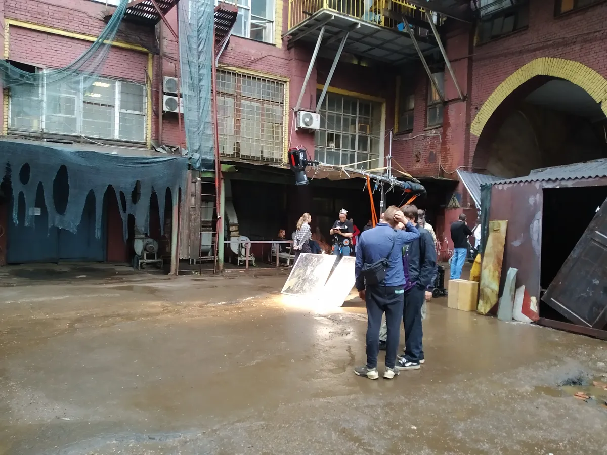 A film and television production set with lighting and equipment.